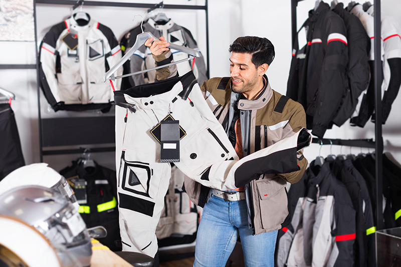 Guy in motorcycle clothing store